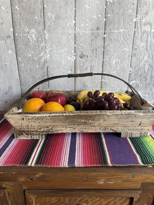 Weathered wood basket with a fixed iron handle