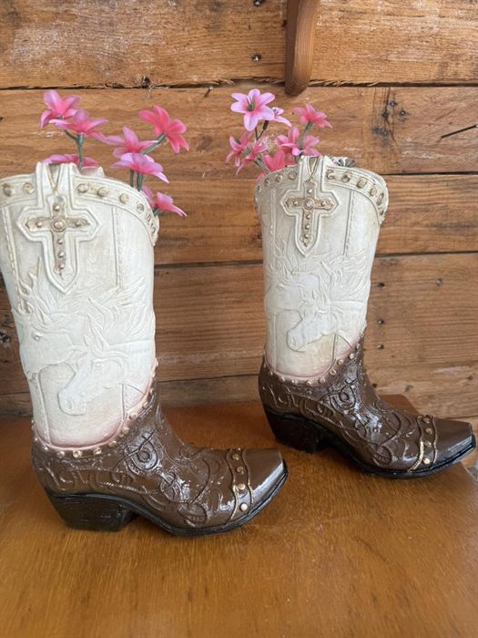 A pair of glazed earthenware boot vases with cross relief