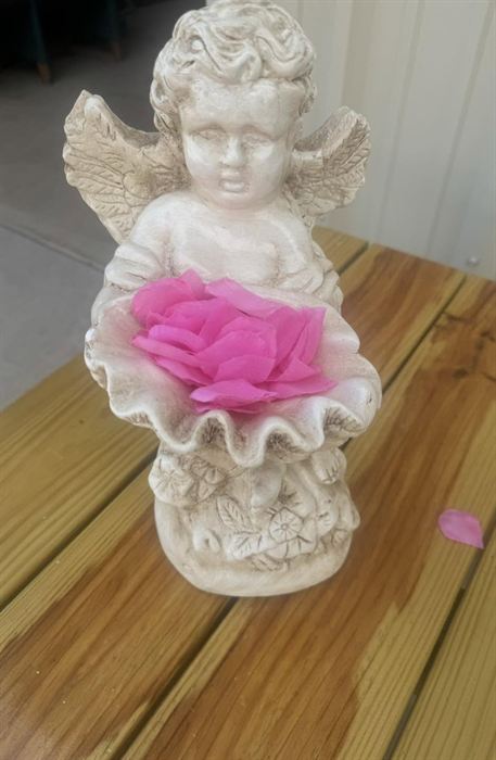 Seated plaster cherub holding a bowl