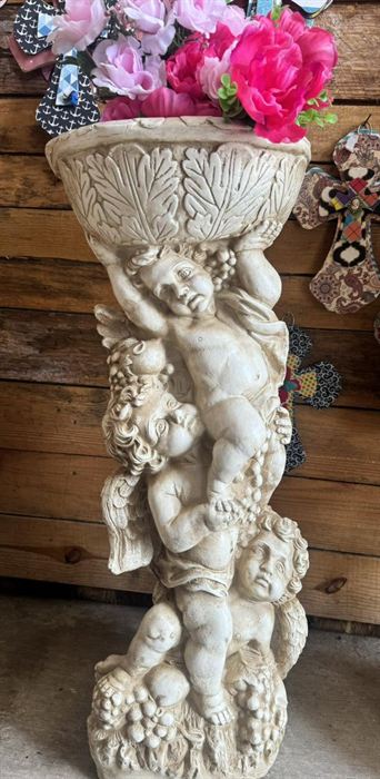 Plaster cherub pedestal planted with flowers