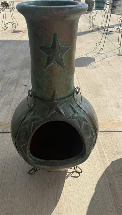 Glazed clay chiminea with a star relief