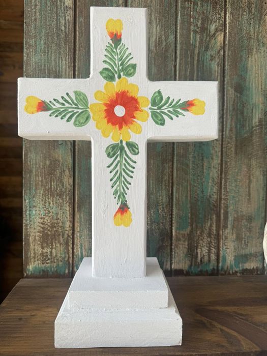 White painted wood cross with a floral motif
