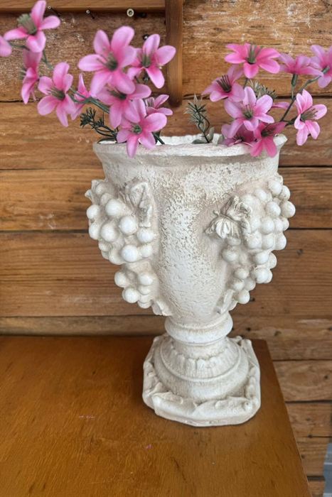Footed plaster vase with grape relief