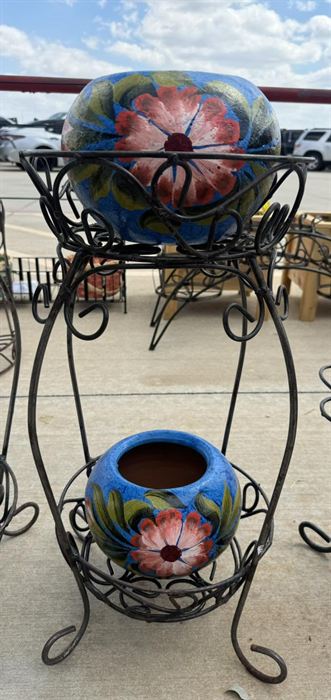 Wrought iron plant stand holding a single talavera pot