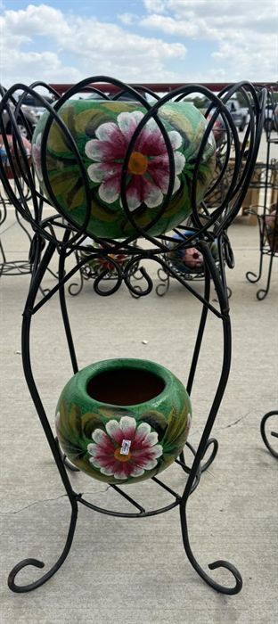 Tiered wrought iron plant stand holding talavera pots