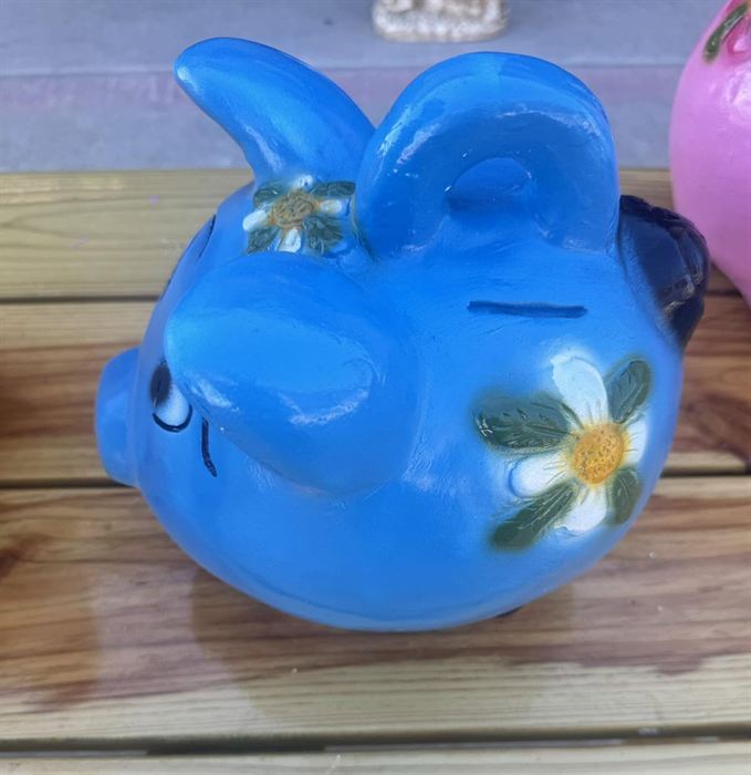 Hand-painted blue clay pig bank with floral detail