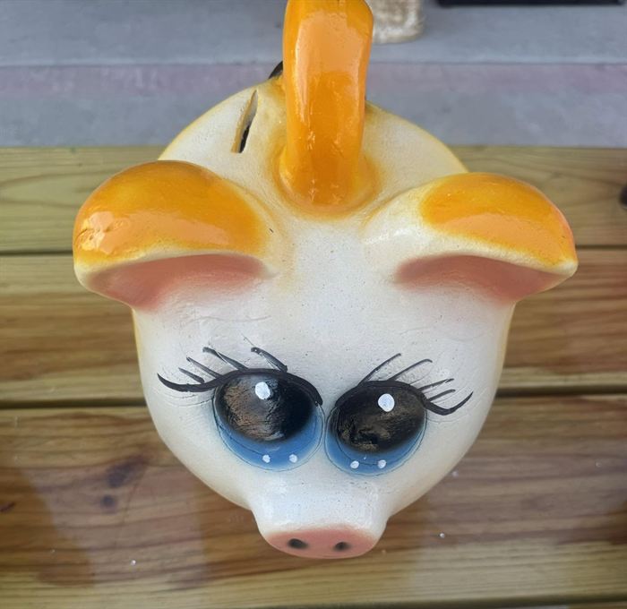 Hand-painted clay pig bank in orange and white