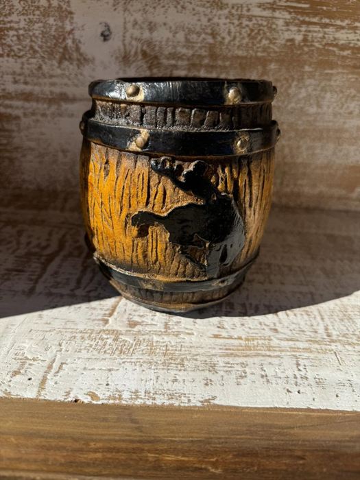 Barrel-form fired clay pot with relief carving