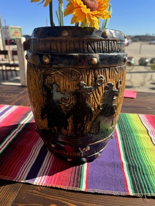 Dark-slipped fired clay pot with relief carving