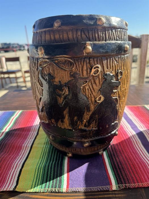 Fired clay pot with figural relief carving