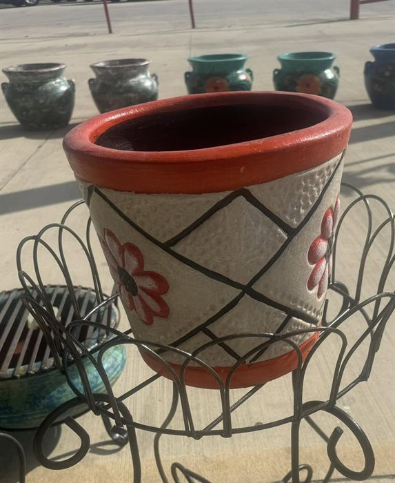 Hand-painted pot with a red rim
