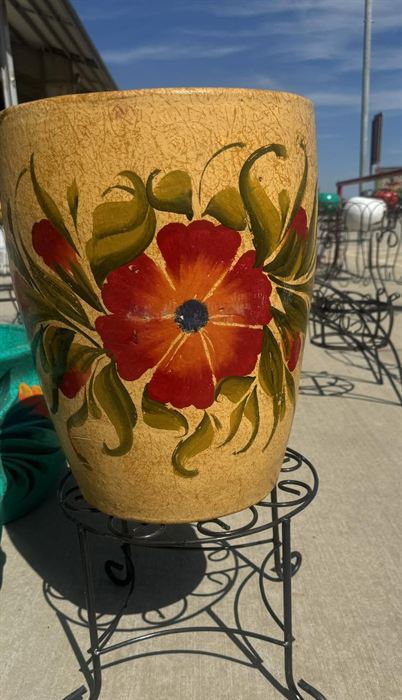 Tall hand-painted floral pot on an iron stand