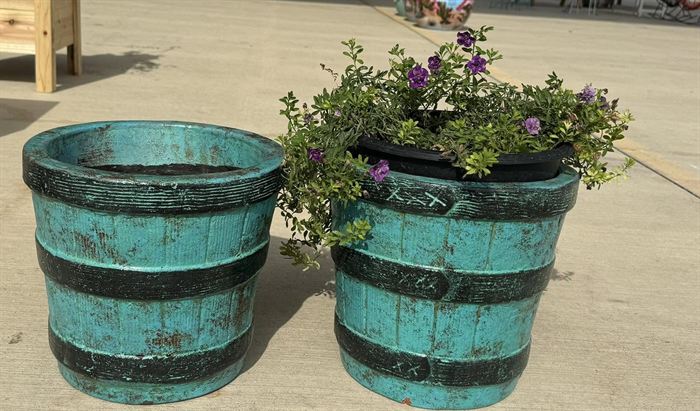 A pair of large banded barrel planters in teal