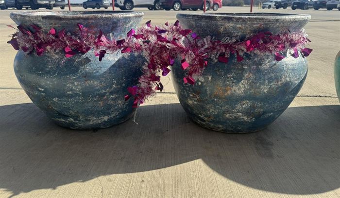 A pair of glazed earthenware pots, planted