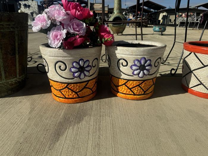 A group of hand-painted white flower pots