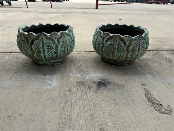 A pair of large green glazed bowls with scalloped rims