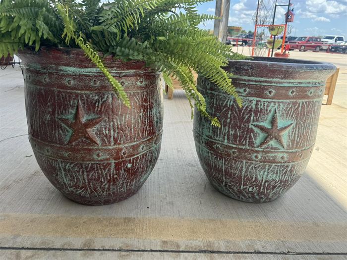 A pair of large clay planters with star relief