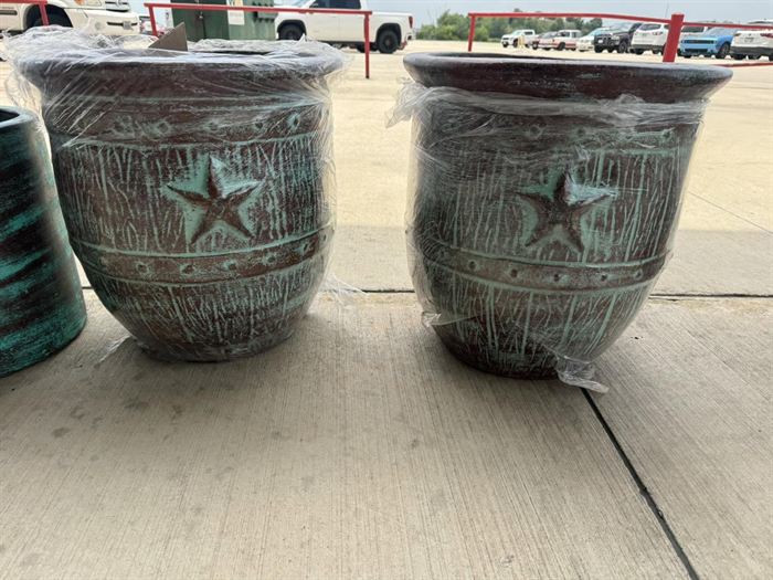 A pair of large glazed planters with star relief