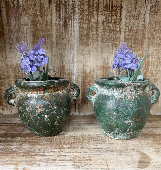 A pair of handled pots with a verdigris glaze