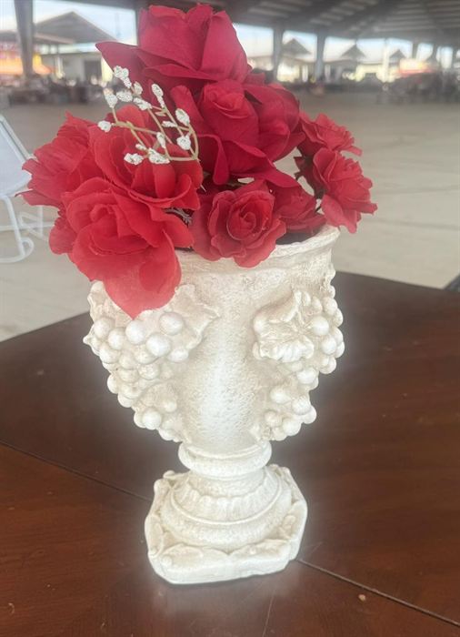 Footed plaster urn with grape relief, planted